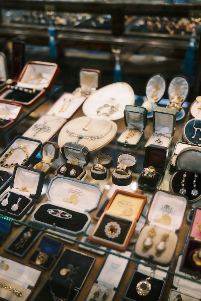 A variety of vintage jewelry pieces showcased in a luxurious display case, offering elegant charm.