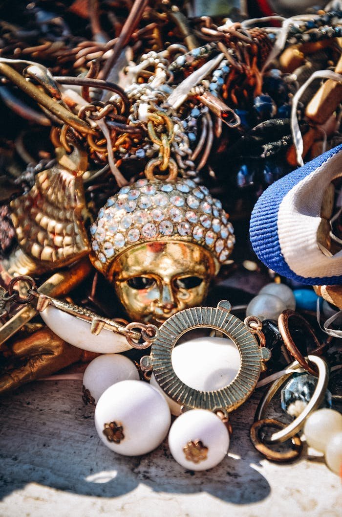 Detailed close-up of assorted vintage jewelry with gold and beads, creating an intricate design.