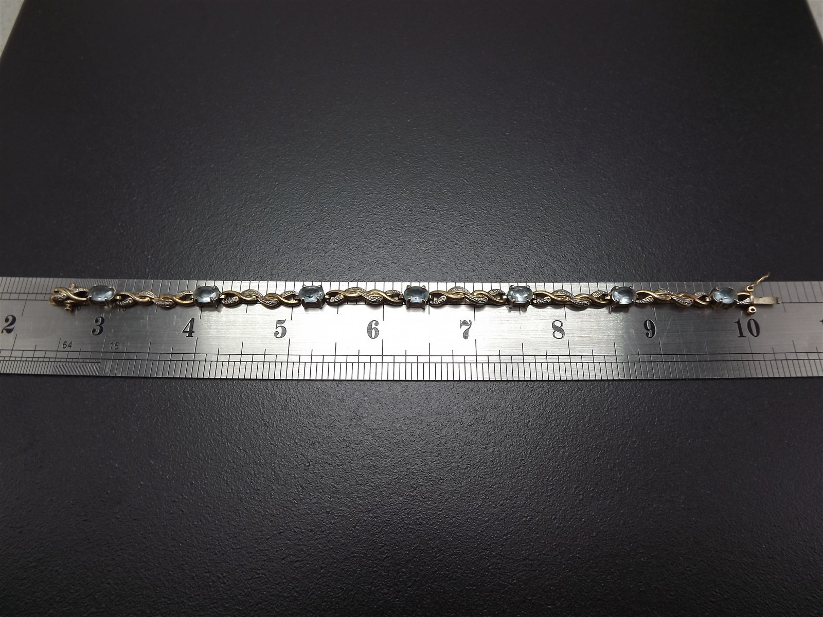 57 1186.jpg Vintage Sterling Silver Blue Topaz Tennis Bracelet – Solid .925 Line Bracelet 8″, 10.1 Grams, Clasp Needs Repair